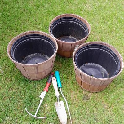 Three flowerpots a small hand shovel, weed puller and rake