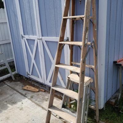 Two ladders, one wooden one smaller metal