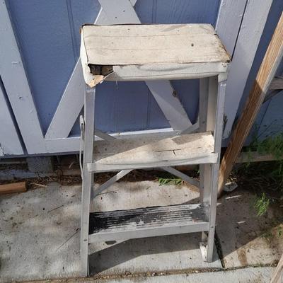 Two ladders, one wooden one smaller metal