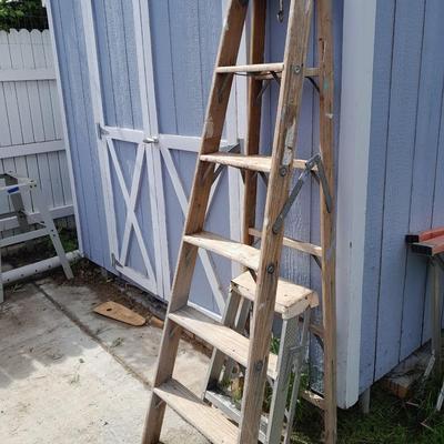 Two ladders, one wooden one smaller metal