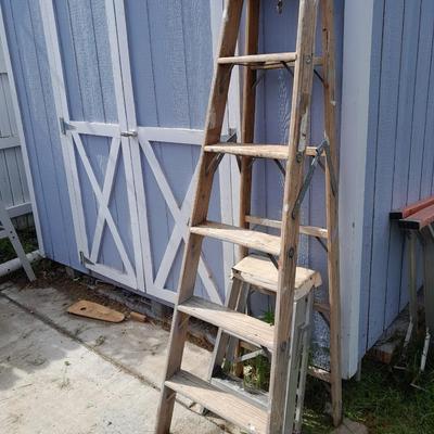 Two ladders, one wooden one smaller metal