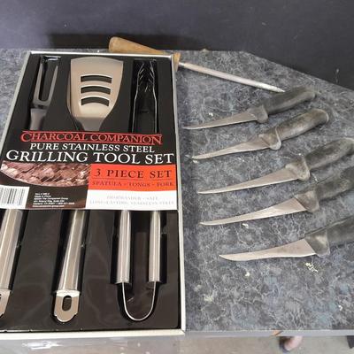 Charcoal Companion stainless steel grilling tool set and several filet knives.
