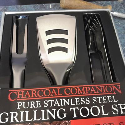 Charcoal Companion stainless steel grilling tool set and several filet knives.