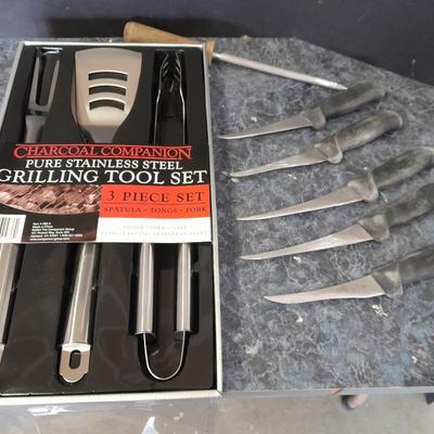 Charcoal Companion stainless steel grilling tool set and several filet knives.