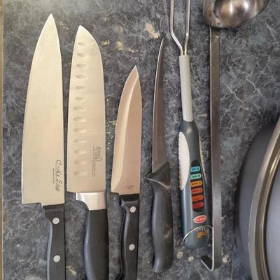 Lidded baking pan with an assortment of knives and electronic thermometer fork