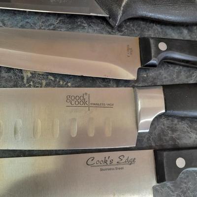 Lidded baking pan with an assortment of knives and electronic thermometer fork