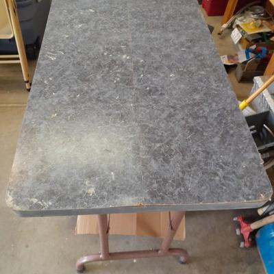 Small folding camper table with two metal chairs