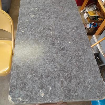 Small folding camper table with two metal chairs