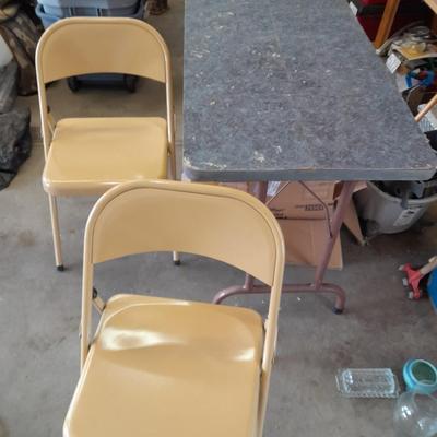 Small folding camper table with two metal chairs