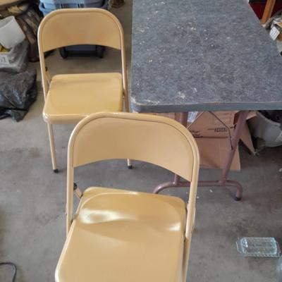 Small folding camper table with two metal chairs