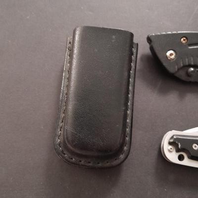 Two pocketknives and a belt sheath
