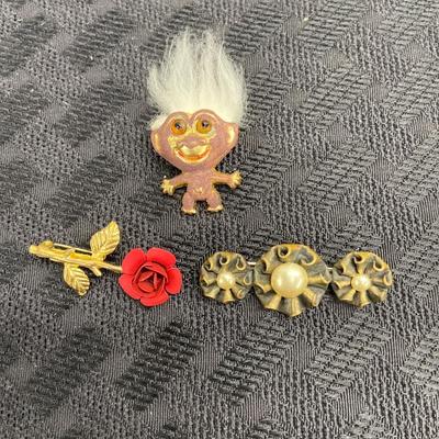Floral and troll pins