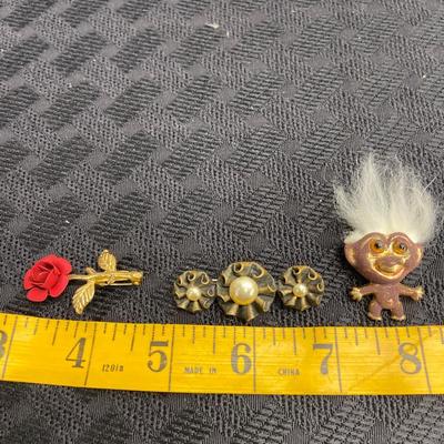 Floral and troll pins