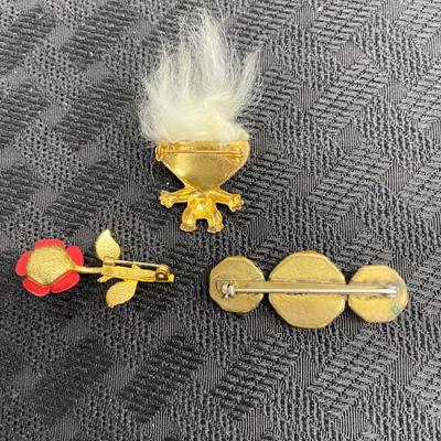 Floral and troll pins