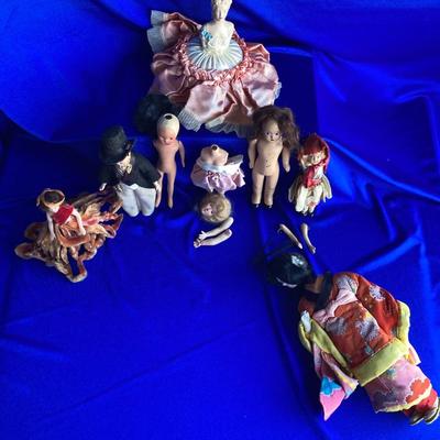 ANTIQUE PIN CUSION AND SOME OLE HEADLESS DOLLâ€™S IN NEED OF NEW RUBBER BANDS