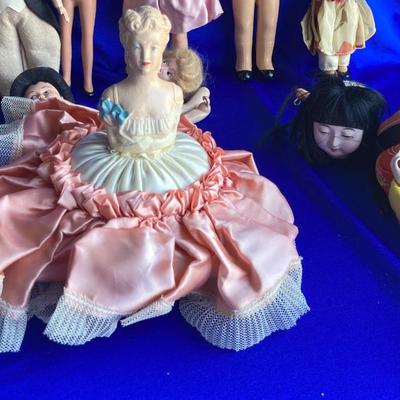 ANTIQUE PIN CUSION AND SOME OLE HEADLESS DOLLâ€™S IN NEED OF NEW RUBBER BANDS