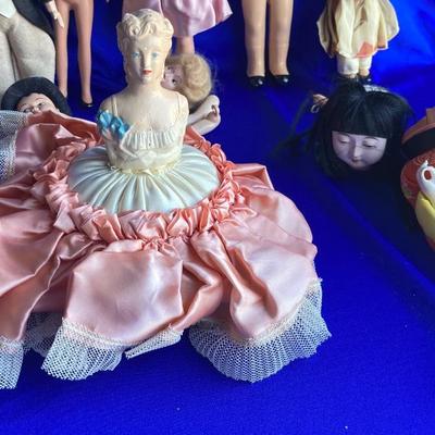 ANTIQUE PIN CUSION AND SOME OLE HEADLESS DOLLâ€™S IN NEED OF NEW RUBBER BANDS