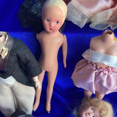 ANTIQUE PIN CUSION AND SOME OLE HEADLESS DOLLâ€™S IN NEED OF NEW RUBBER BANDS