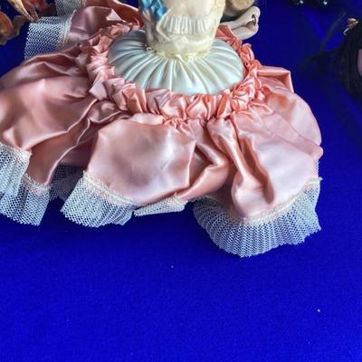 ANTIQUE PIN CUSION AND SOME OLE HEADLESS DOLLâ€™S IN NEED OF NEW RUBBER BANDS
