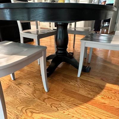 Black Crate & Barrel table with six gray Crate & Barrel chairs
