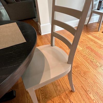 Black Crate & Barrel table with six gray Crate & Barrel chairs