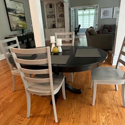 Black Crate & Barrel table with six gray Crate & Barrel chairs