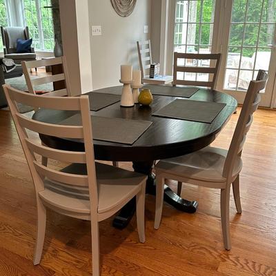 Black Crate & Barrel table with six gray Crate & Barrel chairs