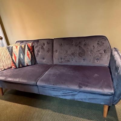 Fun blue velvet sofa that folds down as a day bed