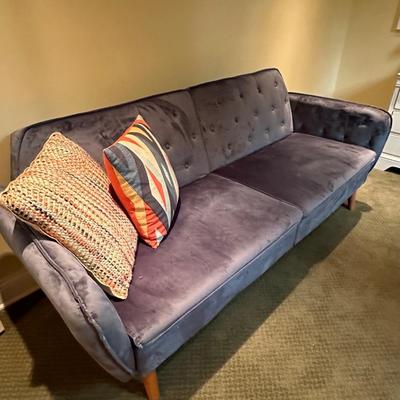Fun blue velvet sofa that folds down as a day bed