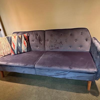 Fun blue velvet sofa that folds down as a day bed