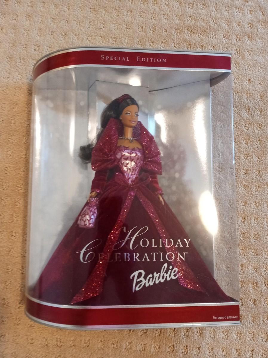SPECIAL EDITION HOLIDAY CELEBRATION BARBIE 2002 EstateSales the-barbie-holiday-celebration-barbie-doll-is-wearing-a-silver-dress