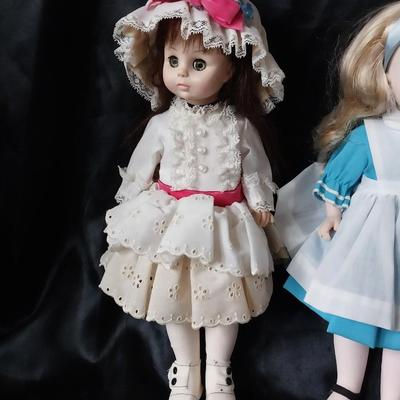 THREE PORCELIAN DOLLS WITH  HAND SEWN OUTFITS