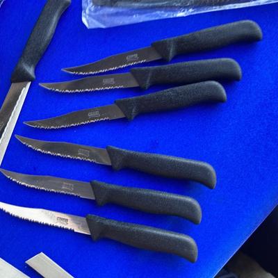 A BRAND NEW SET OF GINSU KNIFES, COOK BOOKS AND SOME OTHER UTENSILS