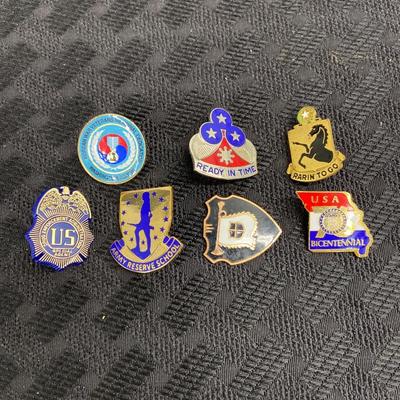 A lot of seven various military pins