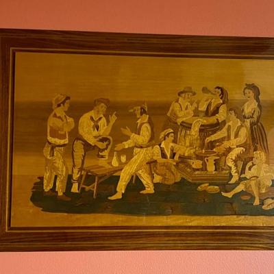 Wood inlay depicting men and women.