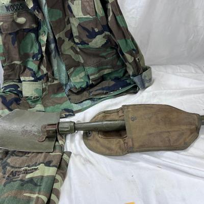 Camouflage Army jacket  M-L marked "Woods"  Folding camp shovel in canvas holder.