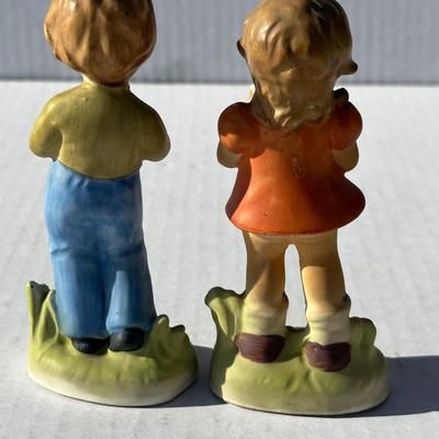 Vintage boy and girl porcelain playing instruments
