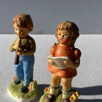 Vintage boy and girl porcelain playing instruments