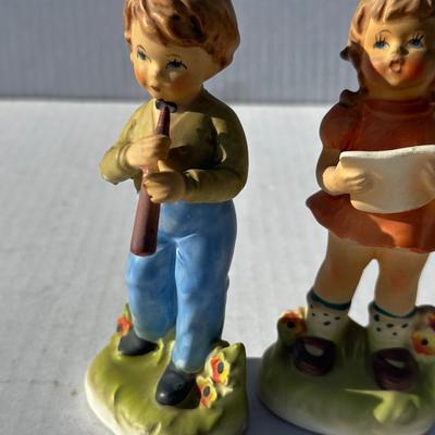 Vintage boy and girl porcelain playing instruments