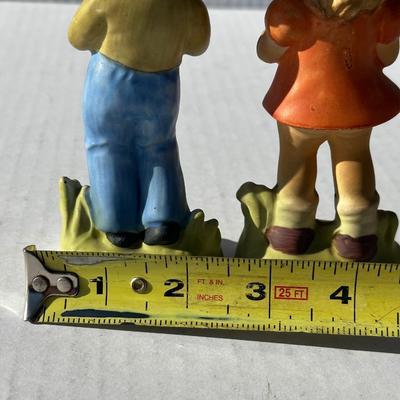Vintage boy and girl porcelain playing instruments