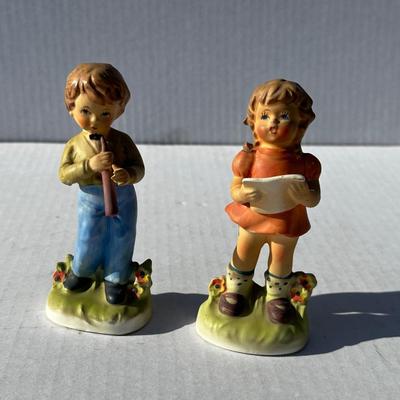 Vintage boy and girl porcelain playing instruments