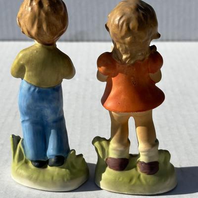 Vintage boy and girl porcelain playing instruments
