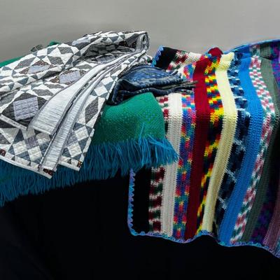 Pile of Throw Blankets both Modern and Vintage