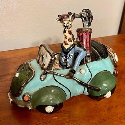 Giraffe driving car