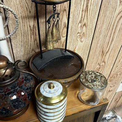 Lot of Bells, Grinder, Candle Holder and Brown Rug. 