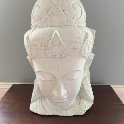 Quan Yin carved from stone statue. The Goddess of Wisdom. Solid wooden stand is included. Statue is 15â€ tall. Table is 18â€ x 13.5â€.