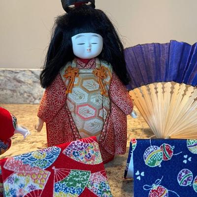 Set of 3 Japanese dolls. One in middle is is wooden. Other Two are not. Comes with â€œchopâ€ which is the signature. 8â€ and 7â€.