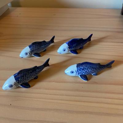 Four porcelain fish chopstick rests.