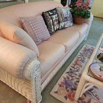 White wicker patio sofa