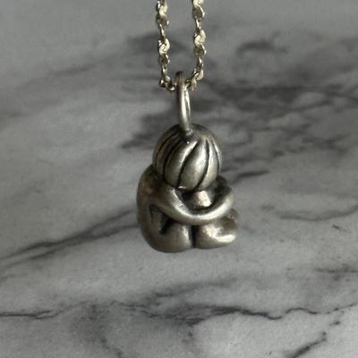 Small sterling silver pendant of child with sterling chain